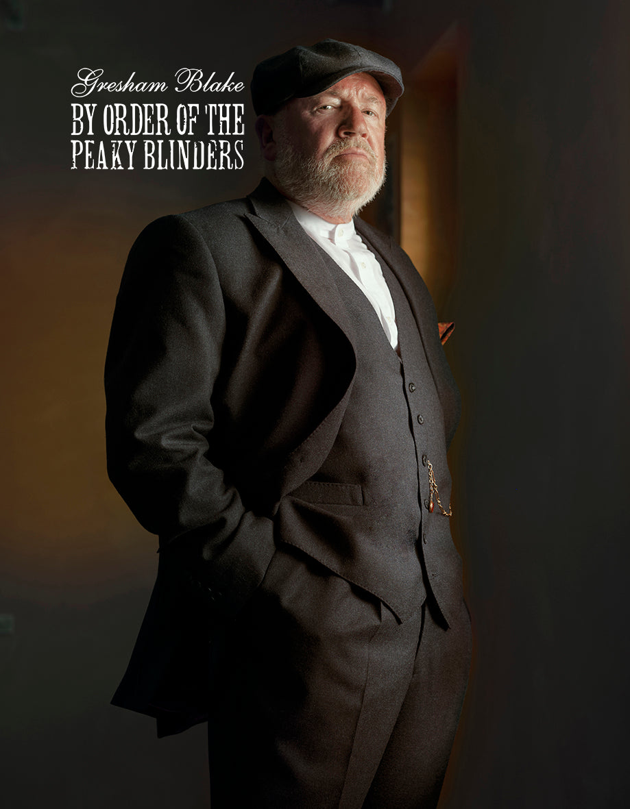 Man in a suit with text 'Gresham Blake By Order of the Peaky Blinders' on a dark background